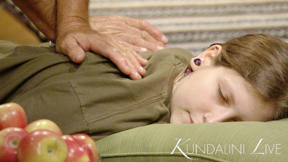 girl receiving massage with apples and hands in yoga class